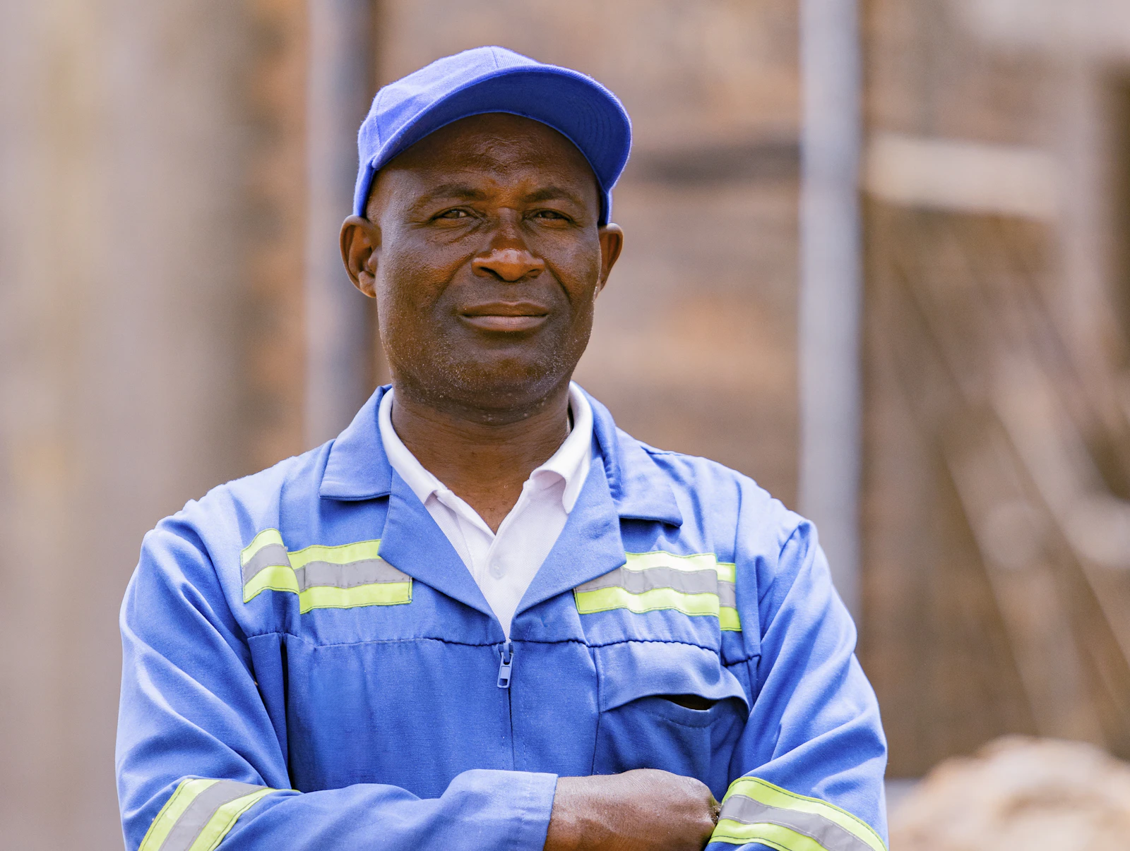 A technician in a blue work uniform and cap